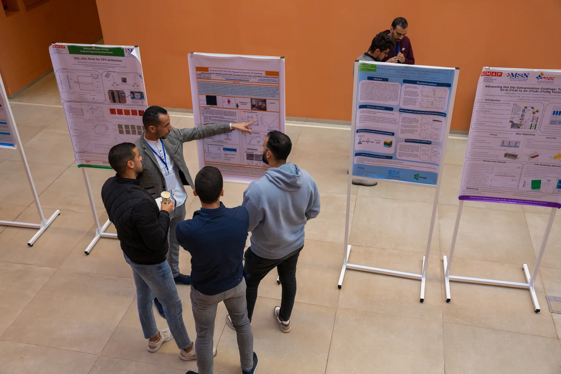Researchers discussing posters